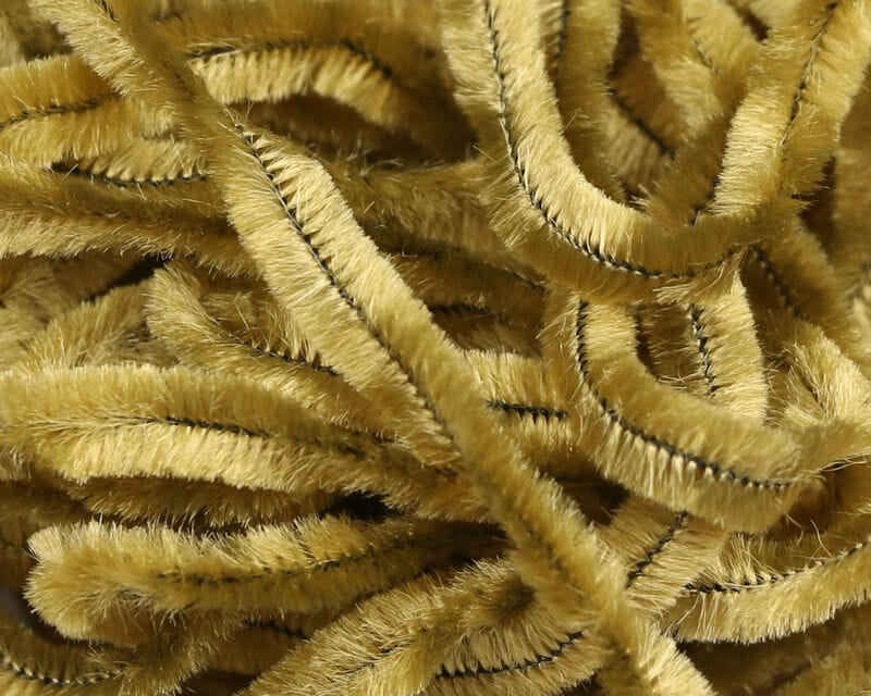 Golden olive Hareline chenille strands, fuzzy velvety texture with thin black ribbing, ideal for fly tying