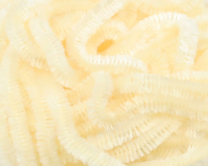 Pale cream Hareline chenille strands with dense fuzzy pile, soft tubular yarn for fly tying and crafting