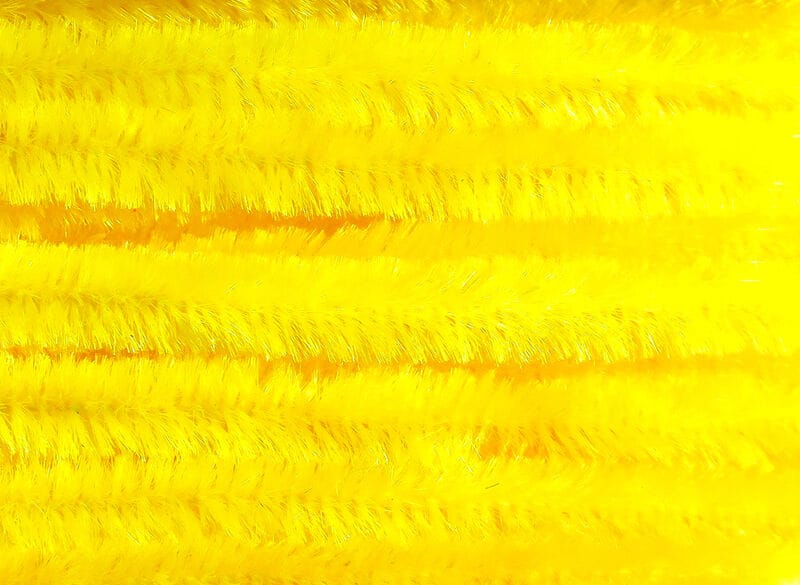 Bright yellow Hareline chenille stems with fuzzy iridescent fibers arranged in parallel rows for fly tying