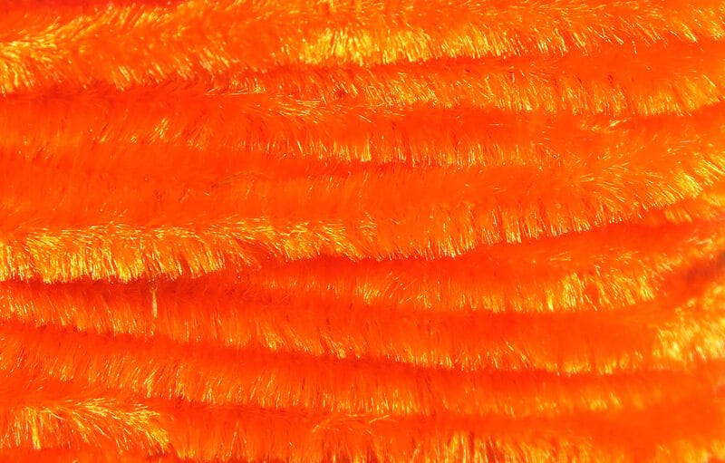 Bright fluorescent orange Hareline chenille with fuzzy, shiny fibers for fly tying bodies and craft accents