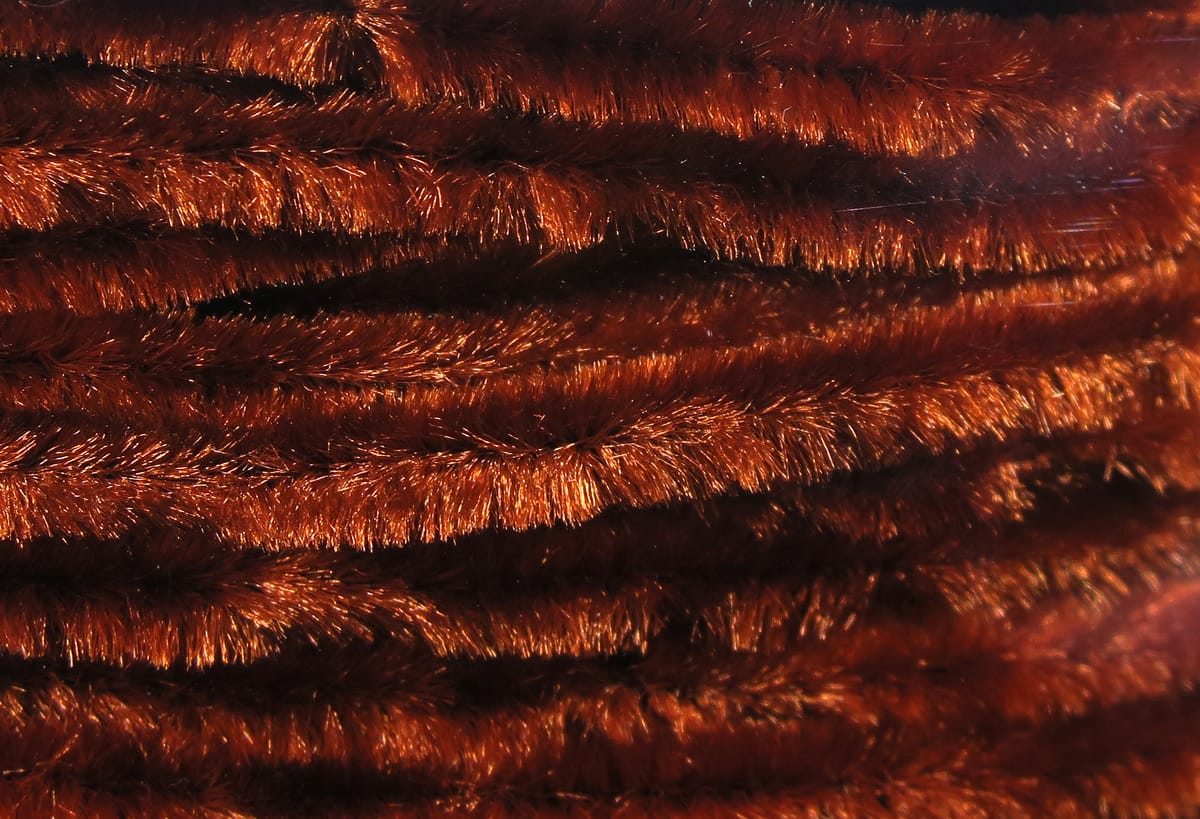Copper brown Hareline chenille with metallic sheen and dense fuzzy fibers for fly tying