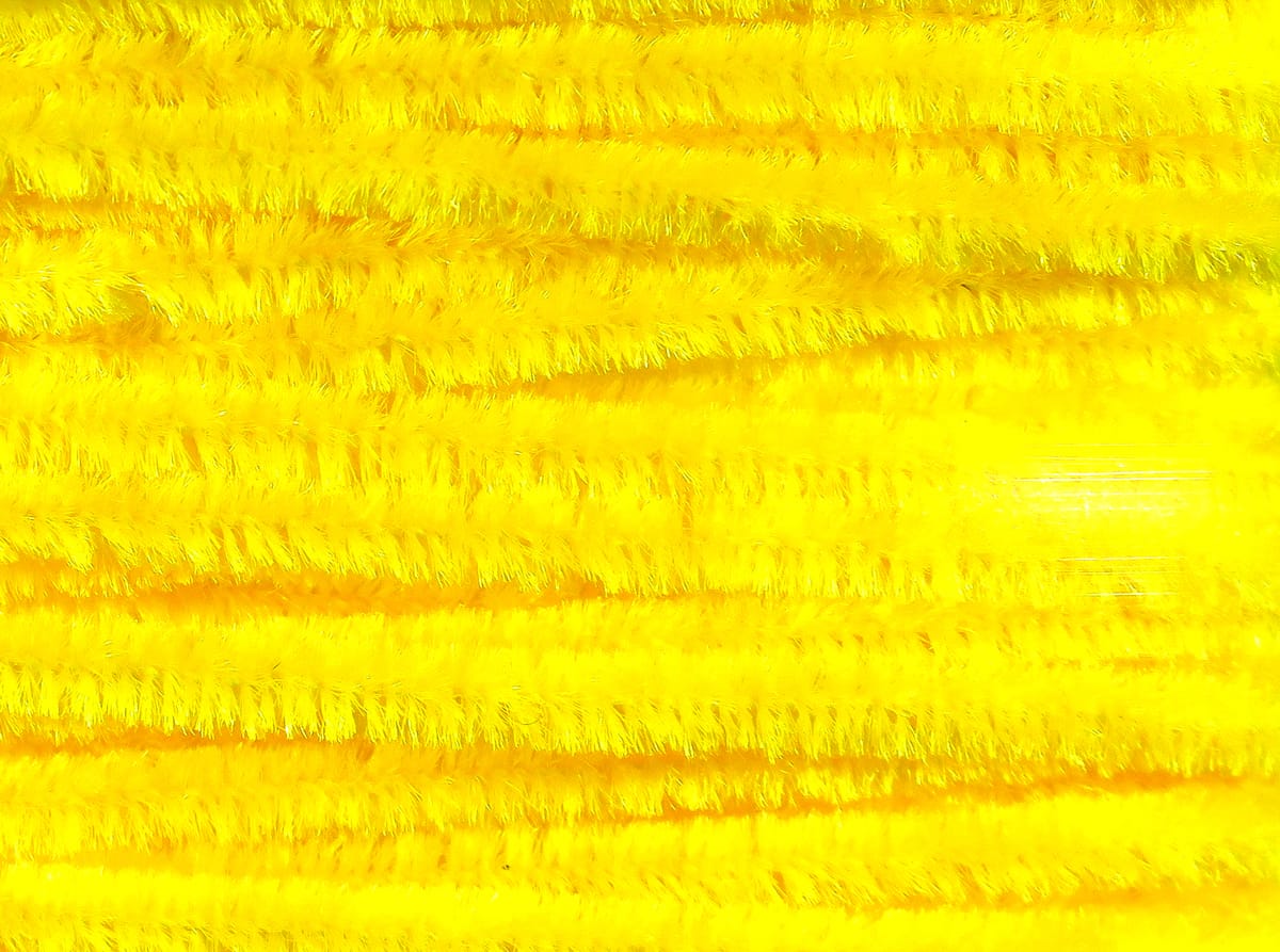 Bright yellow Hareline chenille stems with fluffy iridescent fibers, densely packed and arranged in horizontal rows