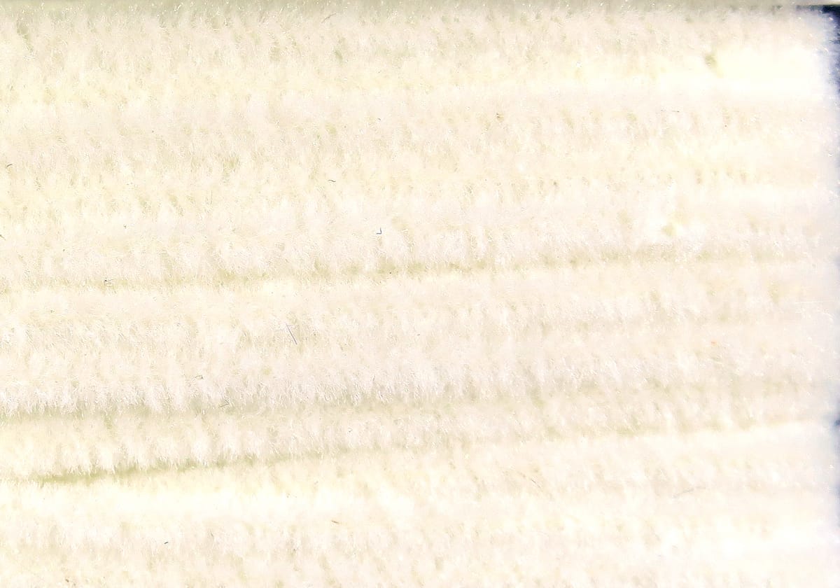 Ivory chenille with soft plush fibers and fuzzy texture, thick strand for fly tying