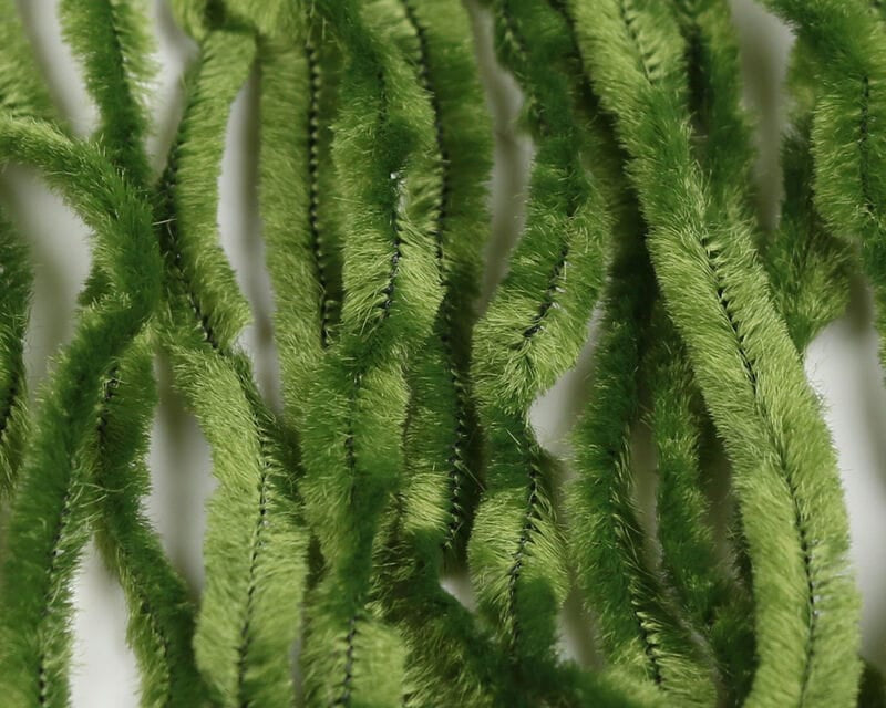 Hareline chenille fly tying material, olive green fuzzy plush strands with soft hairy texture