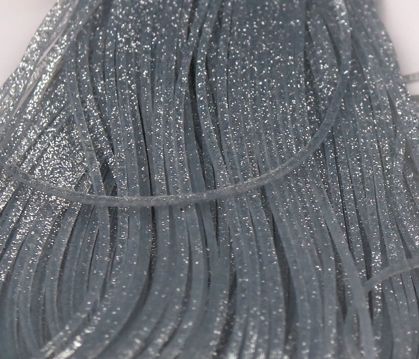 Hareline Crazy Legs gray-blue glitter silicone legs, thin flat rubber strands for fly tying with shimmering silver flecks