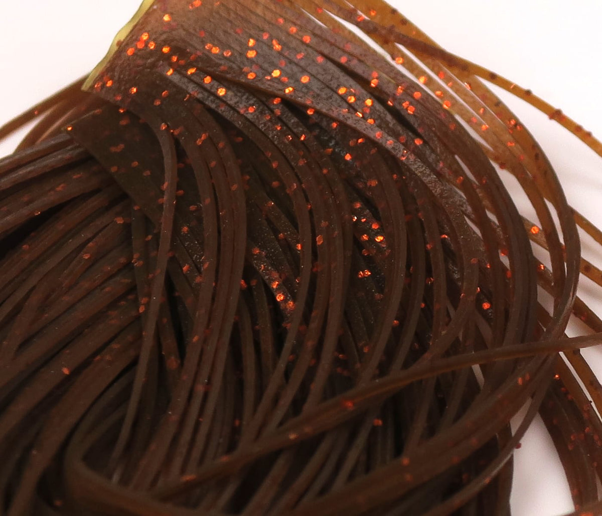 Dark brown rubber legs with orange glitter flecks, thin flat Hareline Crazy Legs strands for fly tying