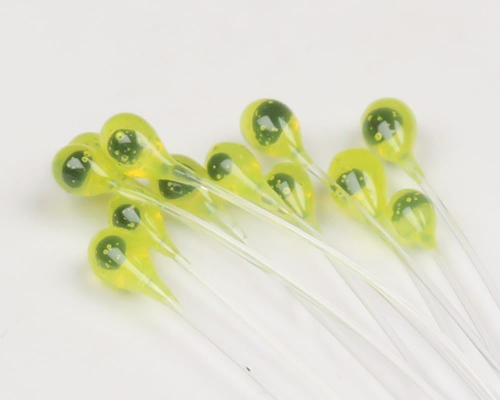 Yellow epoxy mono crab eyes with dark green speckled pupils on clear stems for fly tying