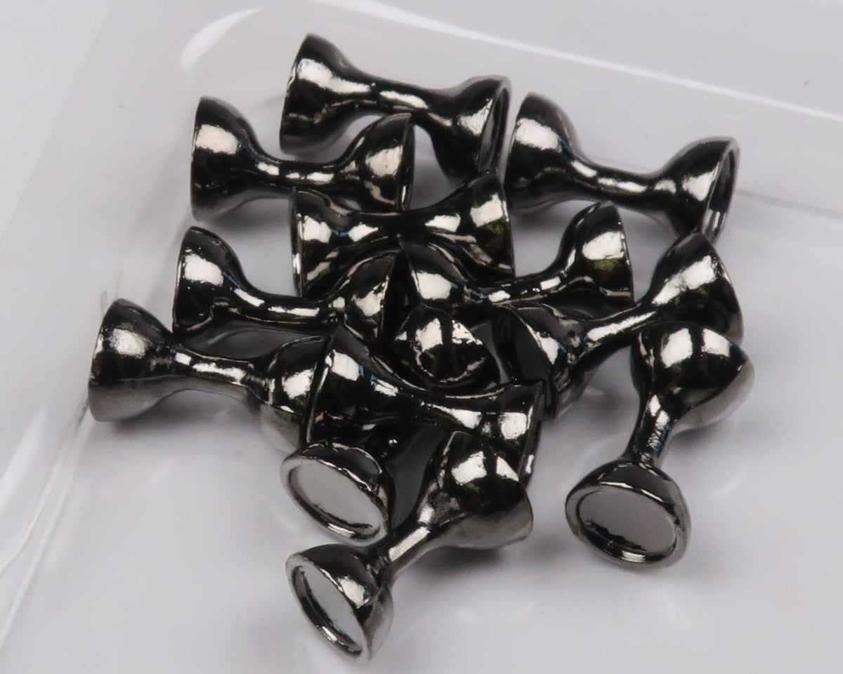 Glossy black tungsten flat-end hourglass eyes for fly tying, metallic low-profile hourglass beads on white surface