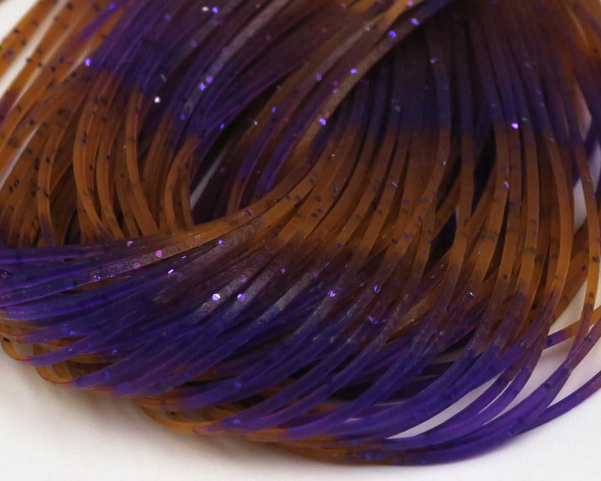 Coiled Hareline fly tying rubber legs, translucent purple and brown with purple glittered thin strands.