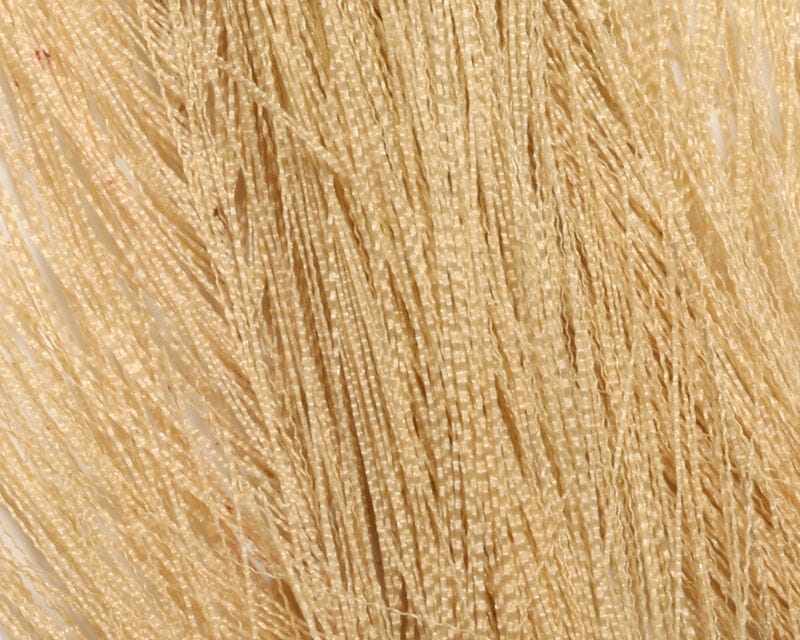 Pale tan synthetic hackle hair with crimped glossy fibers, bundled strands for fly tying