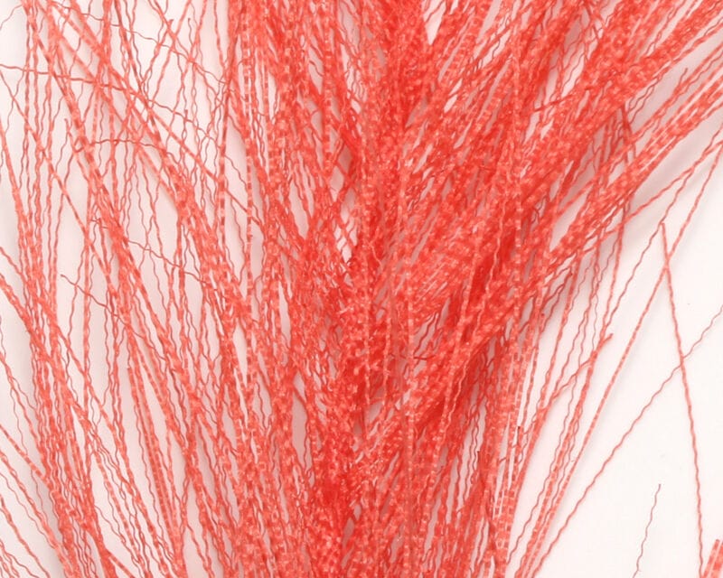 Bright coral-orange Hareline hackle hair, crimped glossy synthetic fibers in a bundled spray for fly tying