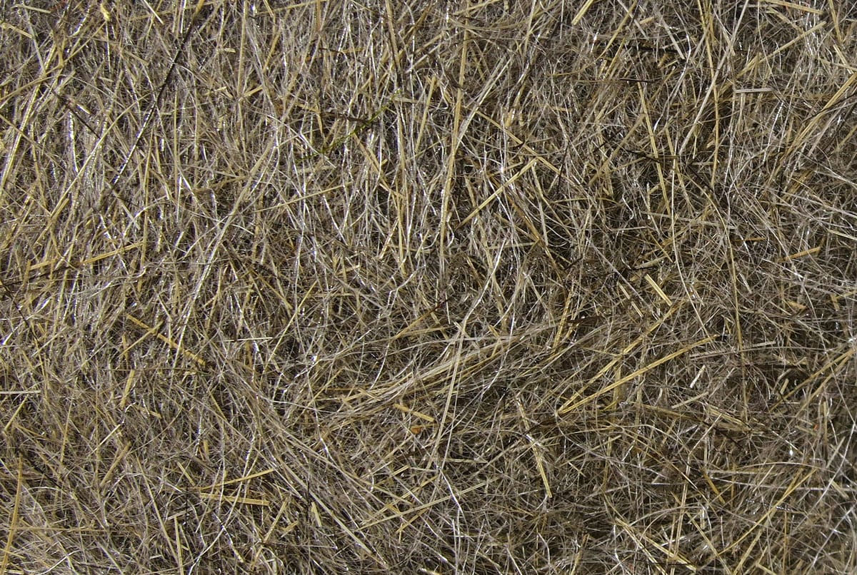 Dense brown and tan hare's ear dubbing fibers with subtle silver flash, natural fur blend for fly tying