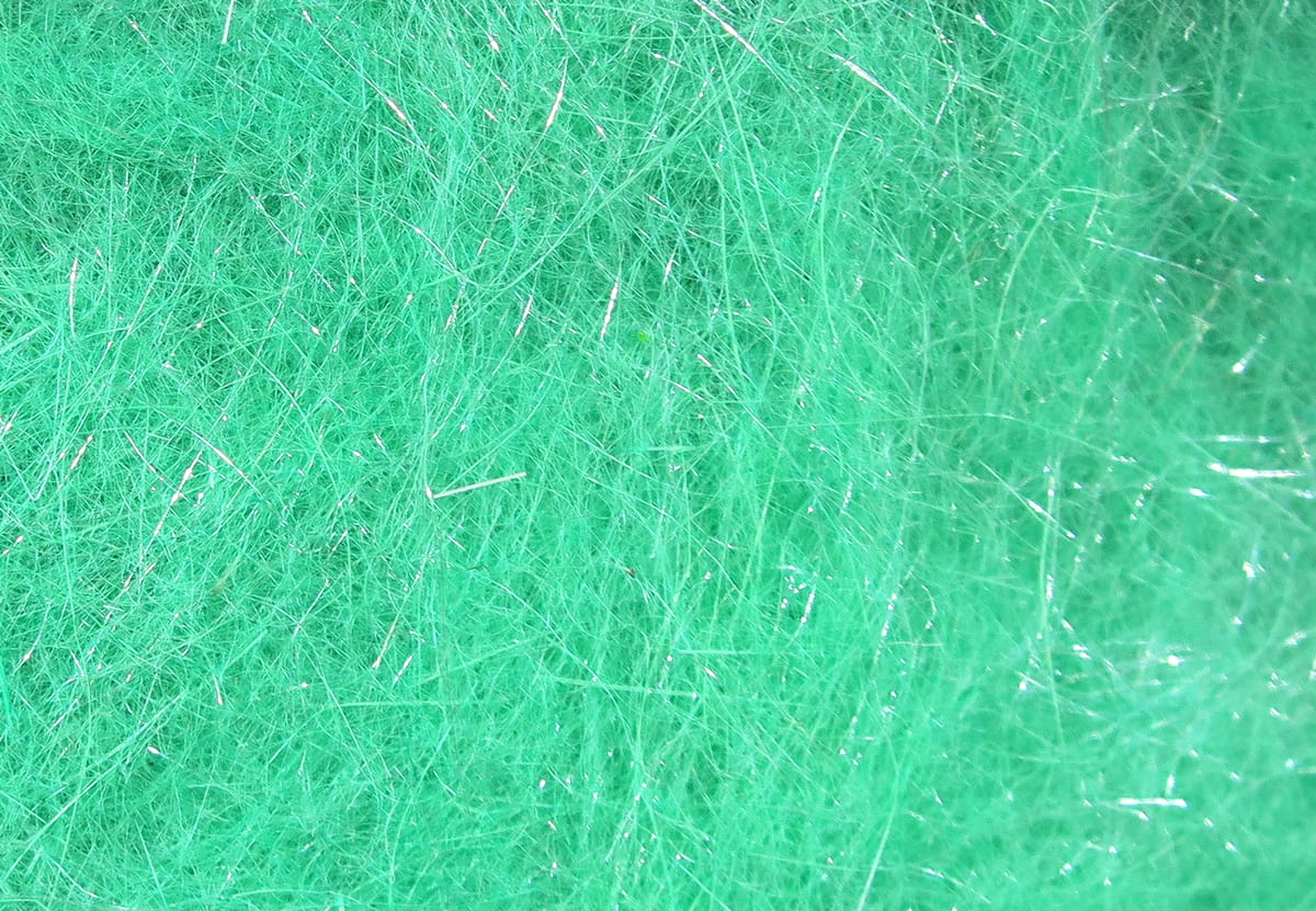 Bright green Hare-Tron dubbing fibers with fine wispy hair and silver flash strands for fly tying.