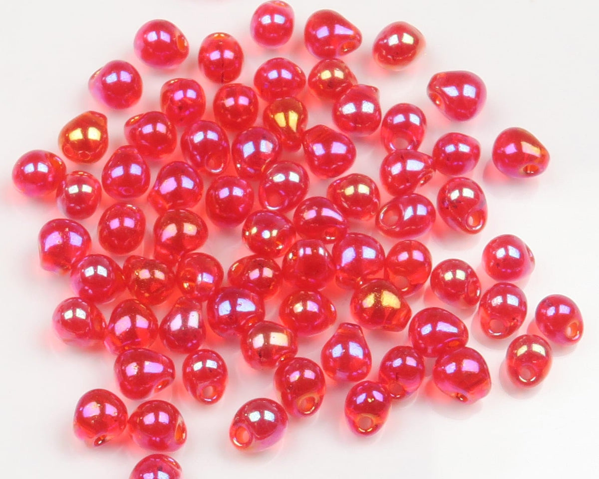Hareline red iridescent humpback glass beads for fly tying, small teardrop shapes with centered holes