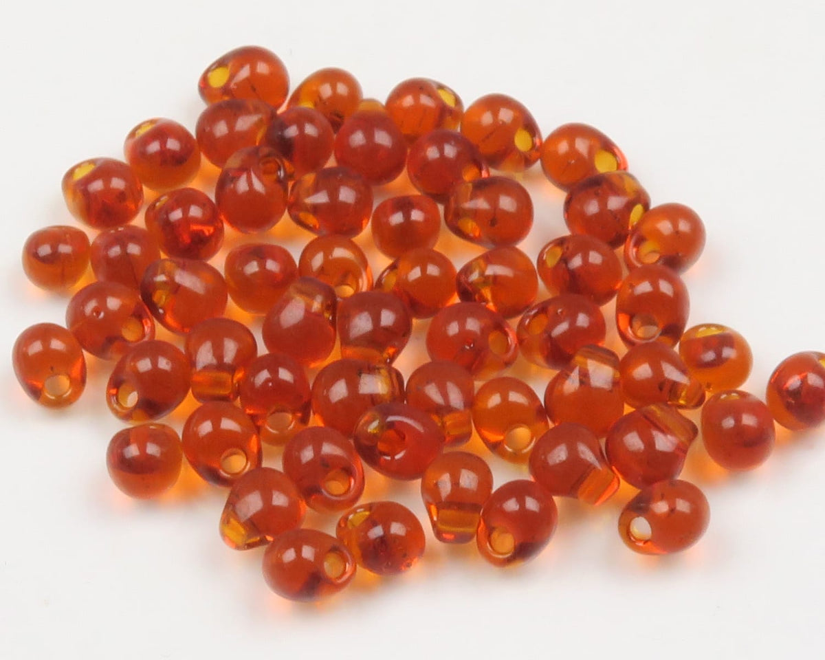 Amber translucent hump-back glass beads with center holes for fly tying