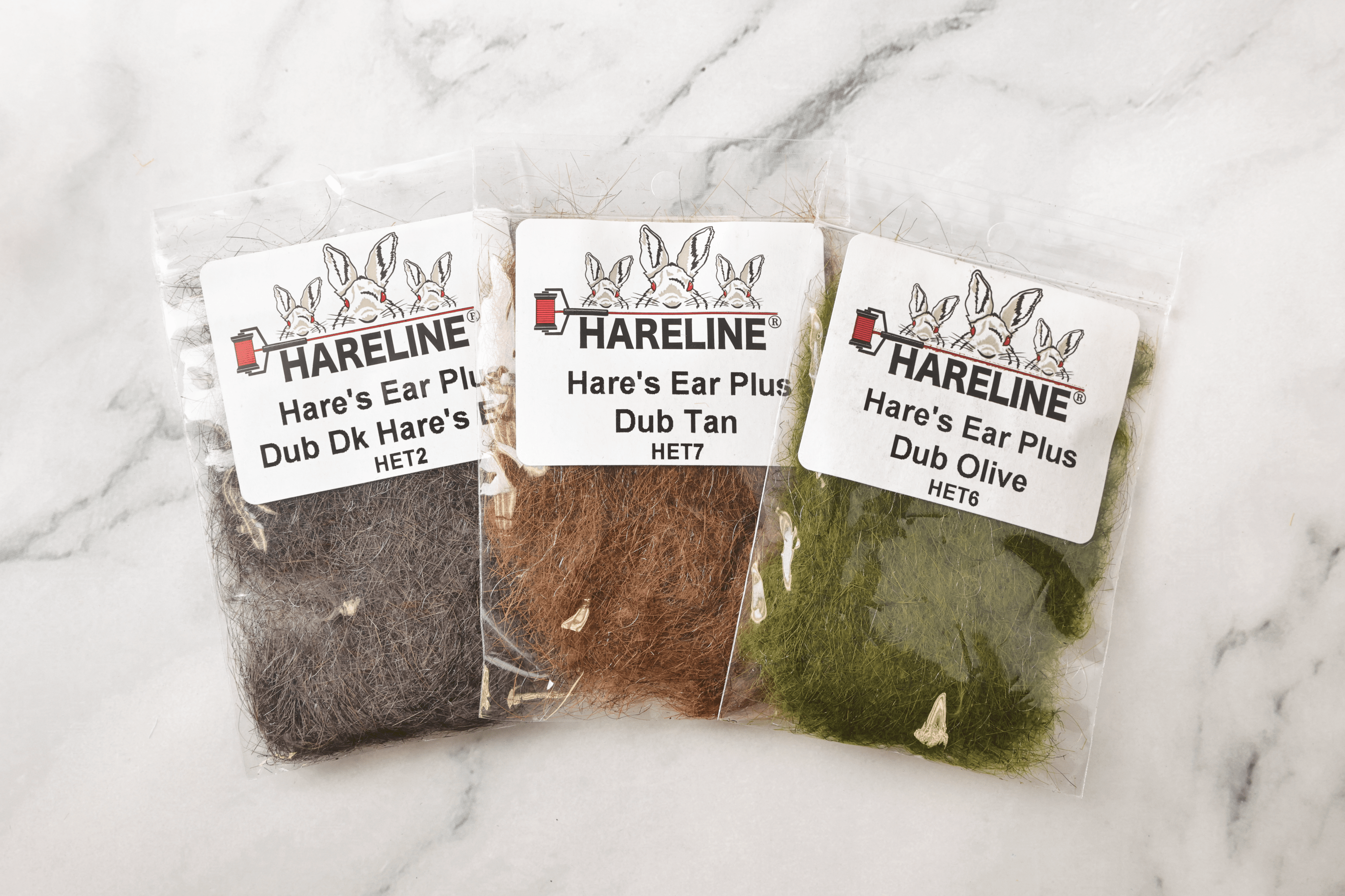 Three Hareline Hare's Ear Plus fly tying dubbing packs — fibrous hare hair in dark brown, tan and olive