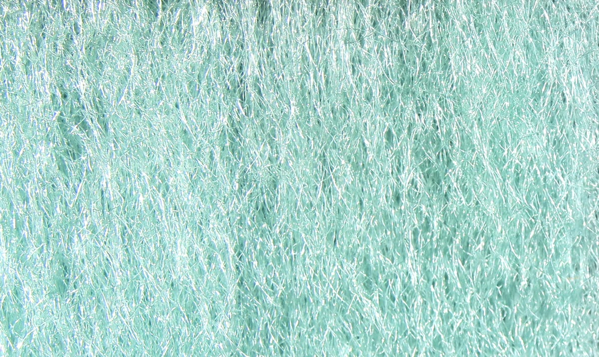 Pale aqua Hareline Ice Fur showing fine synthetic fibers with iridescent flash, shimmering texture for fly tying