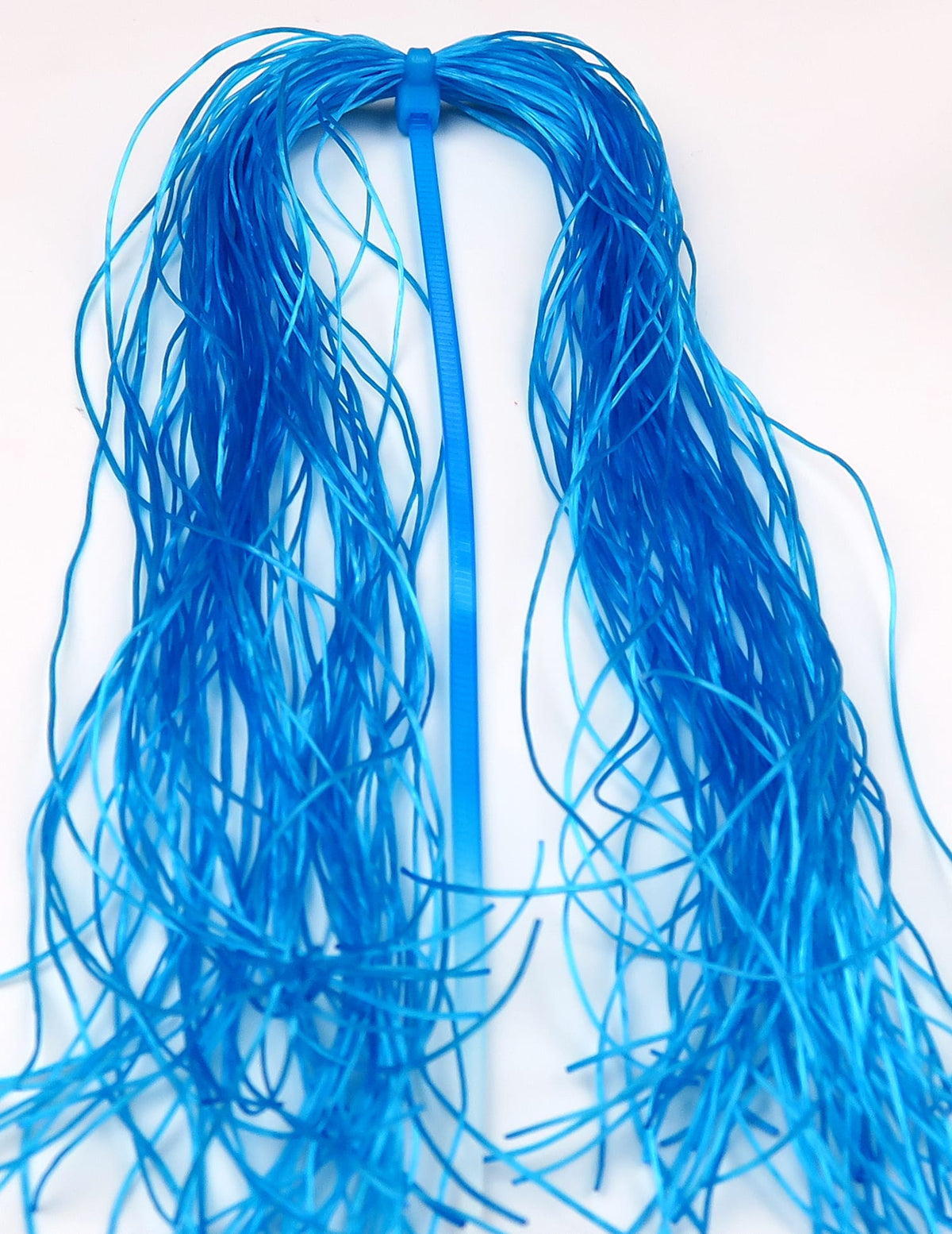 Hareline Life-Flex bright blue flexible rubber strands for fly tying, long thin skirt material bundled on a blue tab