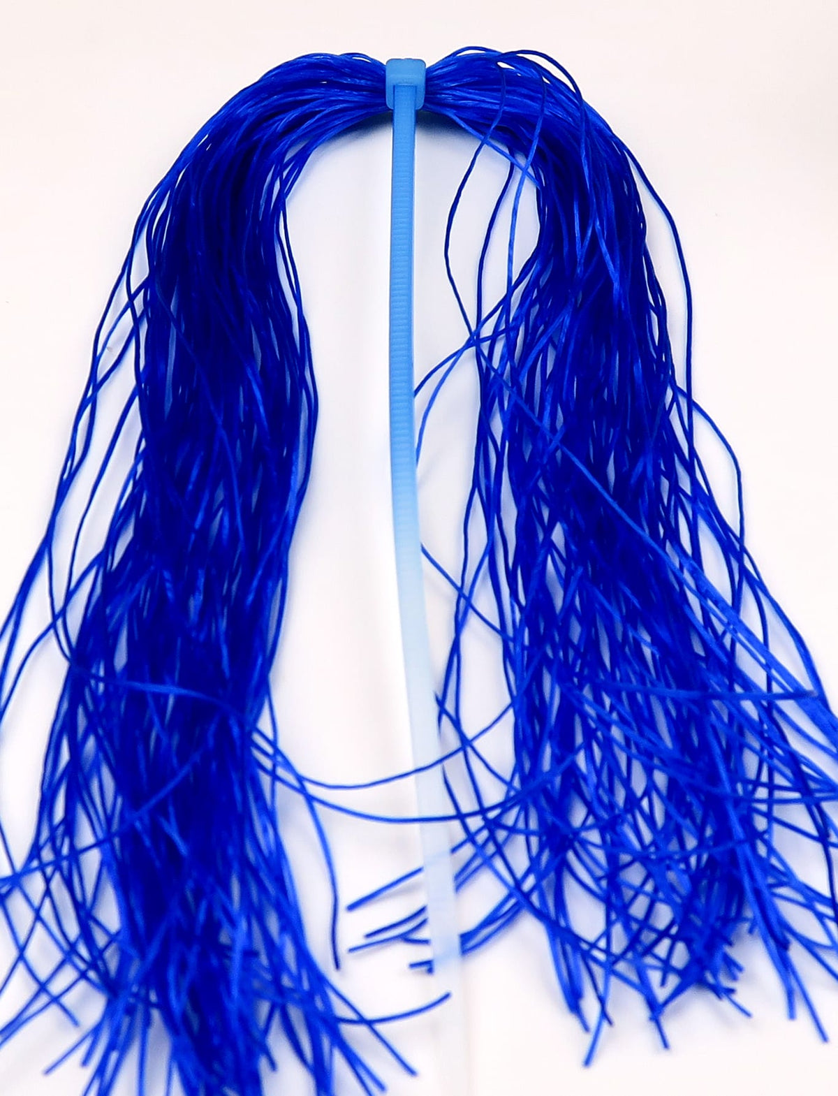 Royal blue Life-Flex flexible synthetic strands secured with light-blue tie, thin rubbery fly tying legs