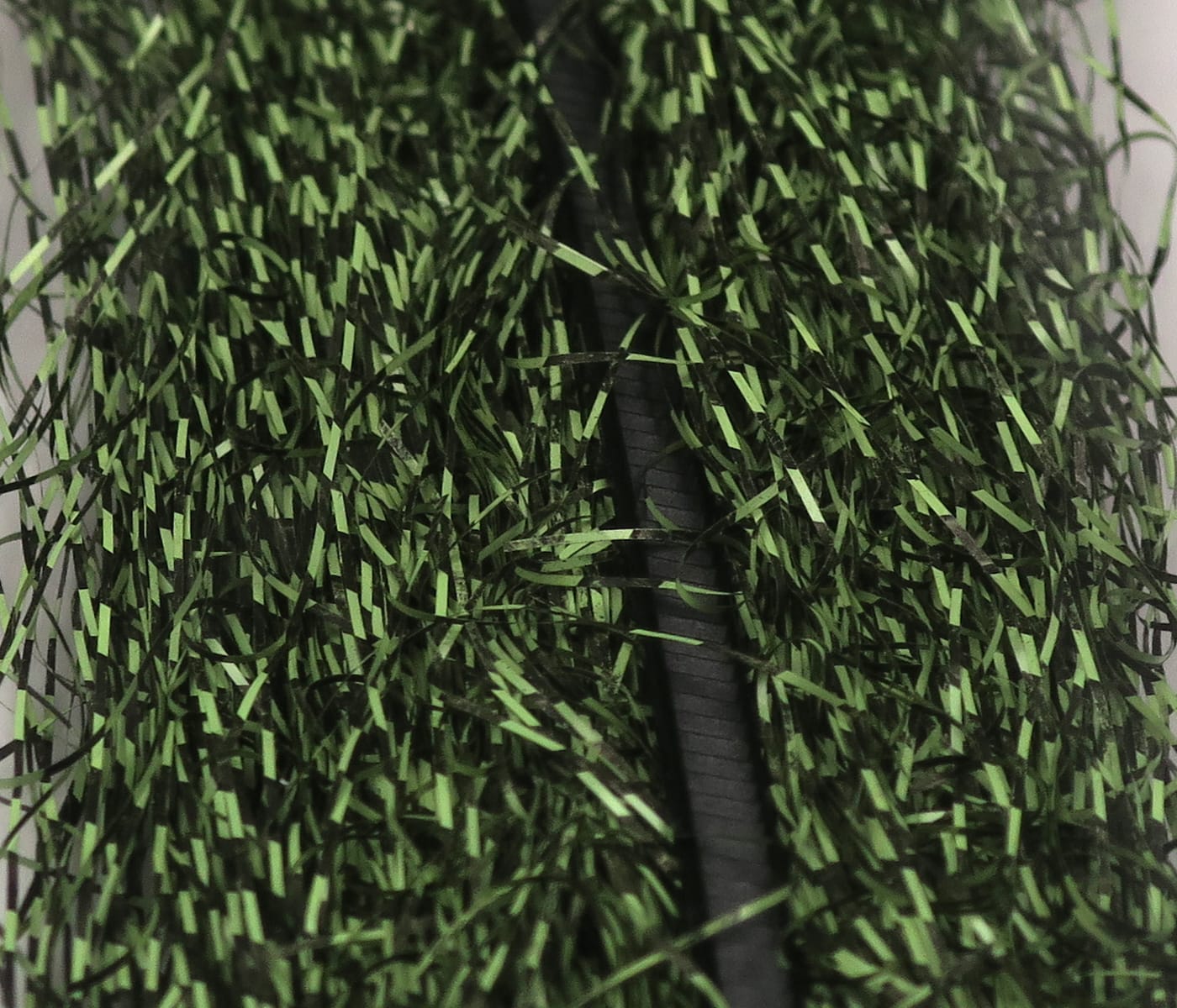 Olive green and black micro barred synthetic fibers, densely packed shiny strands for fly tying