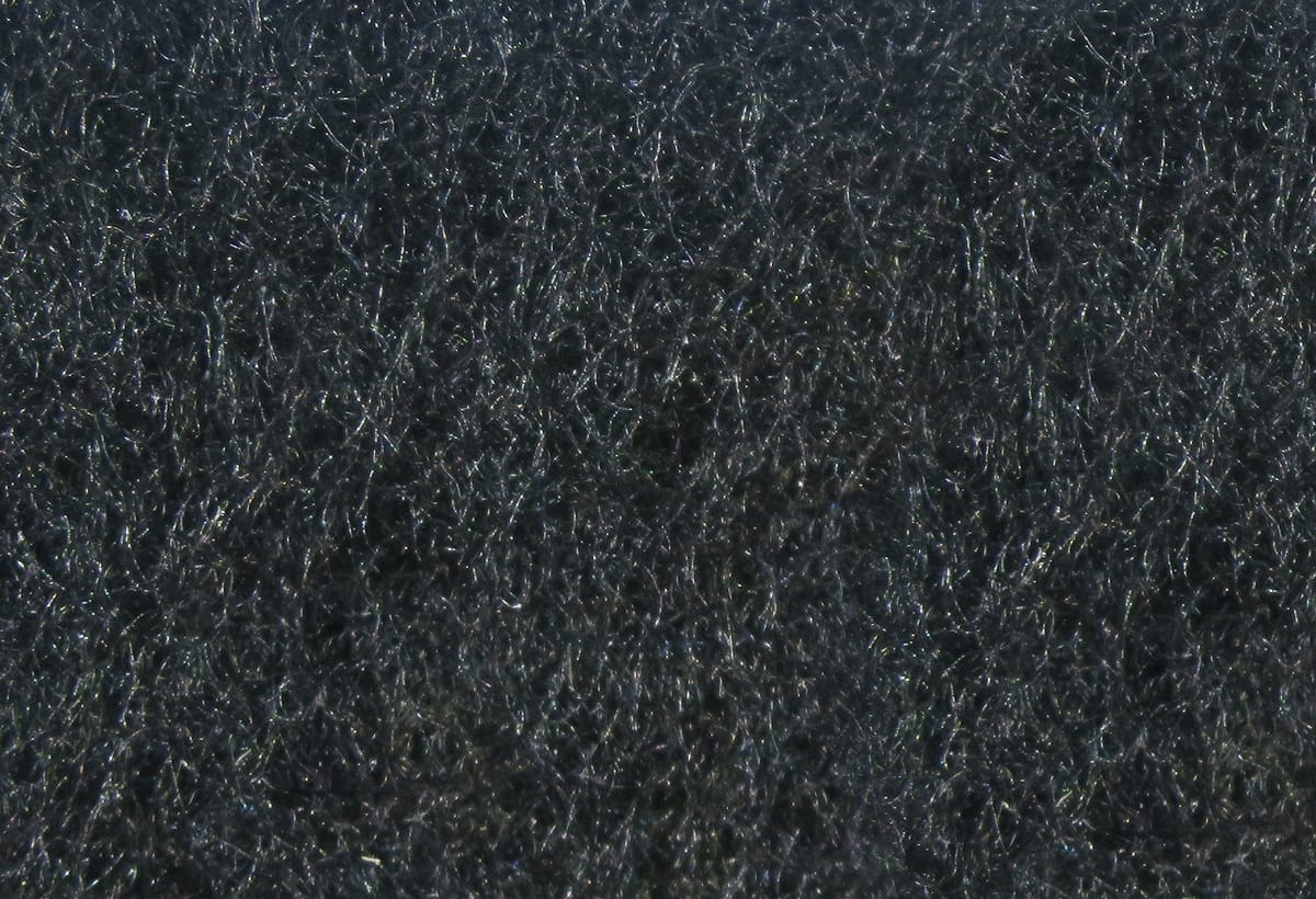 Dark charcoal Hareline micro dry fly dubbing fibers with fine, fuzzy texture and subtle iridescent sheen for fly tying