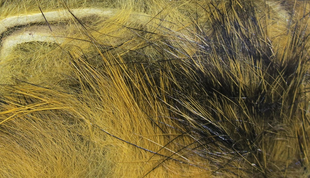 Hareline Micro Pulsator strips: golden tan and black fine synthetic hair with glossy, wispy fibers for fly tying