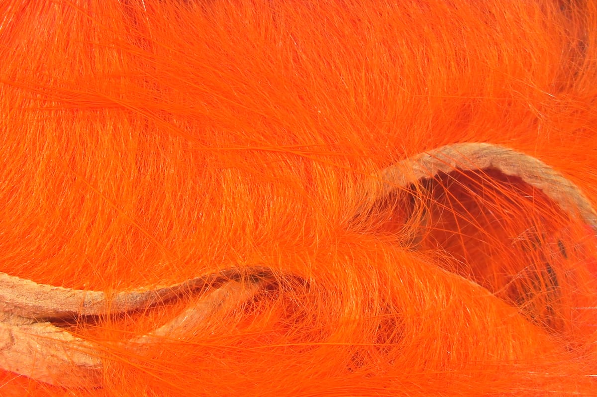 Bright orange micro rabbit fur strips with leather backing, soft fine fur for fly tying