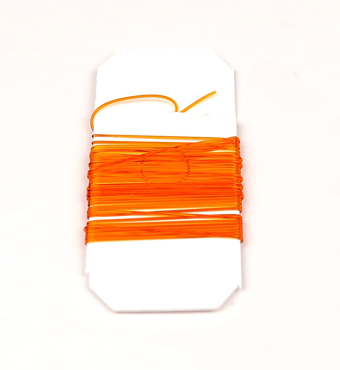 Bright orange stretch rib elastic wound on white card for fly tying