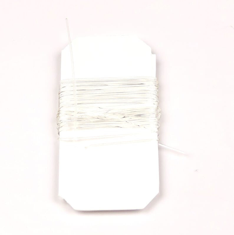 Hareline translucent white midge stretch rib tubing wound on white card, thin elastic rib material for fly tying