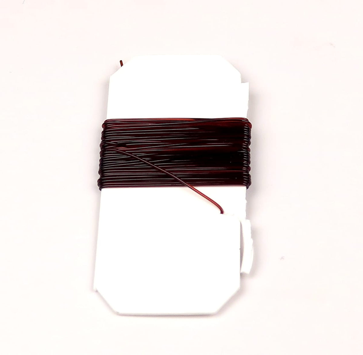 Dark burgundy Hareline midge stretch rib wrapped on white card, thin glossy elastic rib for fly tying