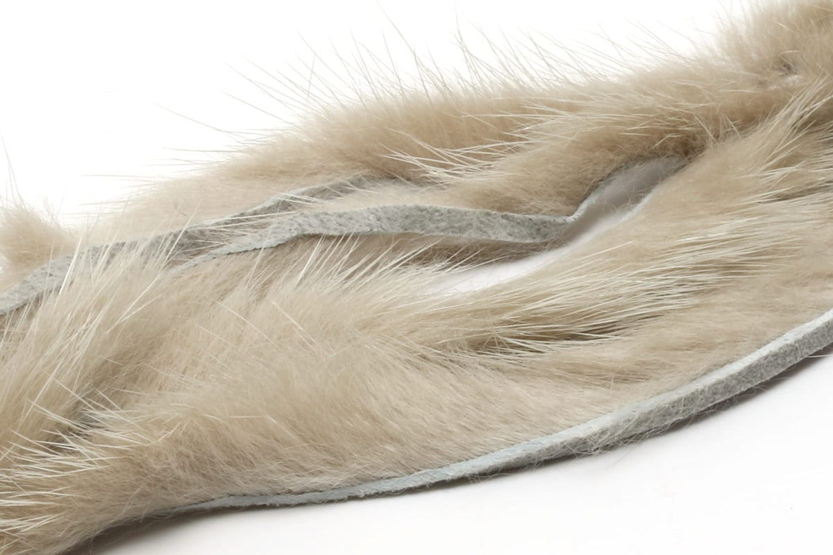 Light tan Hareline mink strips with soft long fur and gray suede backing, ideal for fly tying