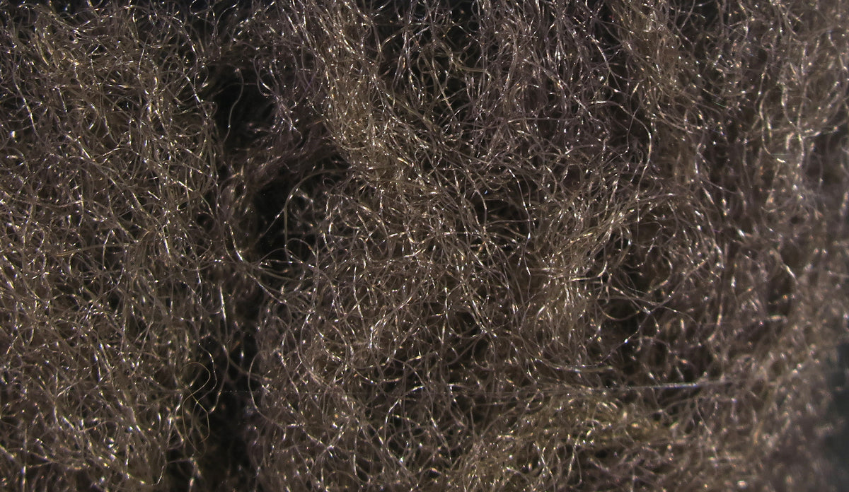 Olive-gray translucent synthetic para post wing fibers with curly, shimmering strands for fly tying