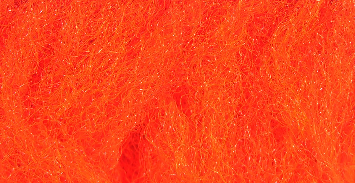 Bright orange synthetic Para Post wing fibers, fine curly strands with subtle sparkle for fly tying