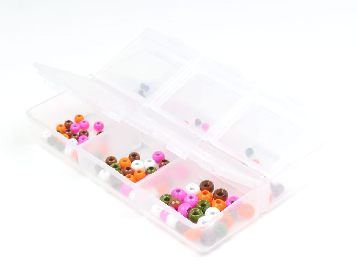 Assorted glossy tungsten beads (pink, orange, brown, white, green) in clear compartment box for fly tying