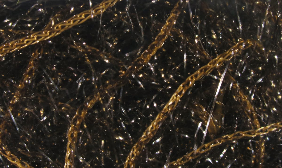 Black polar chenille with gold braided strands and shimmering tinsel fibers for fly tying