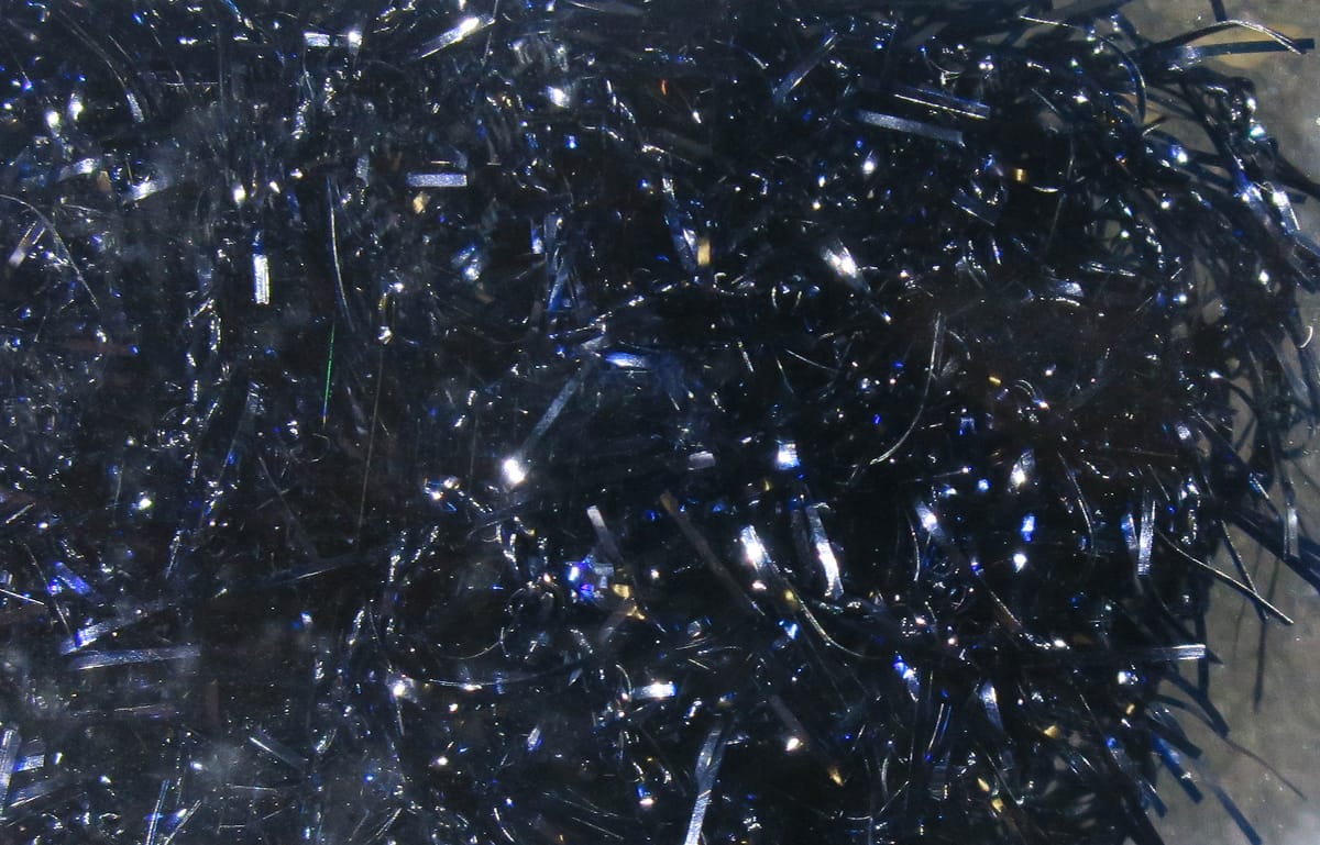Hareline Polar Chenille dark navy black synthetic chenille with glossy blue iridescent tinsel strands for fly tying