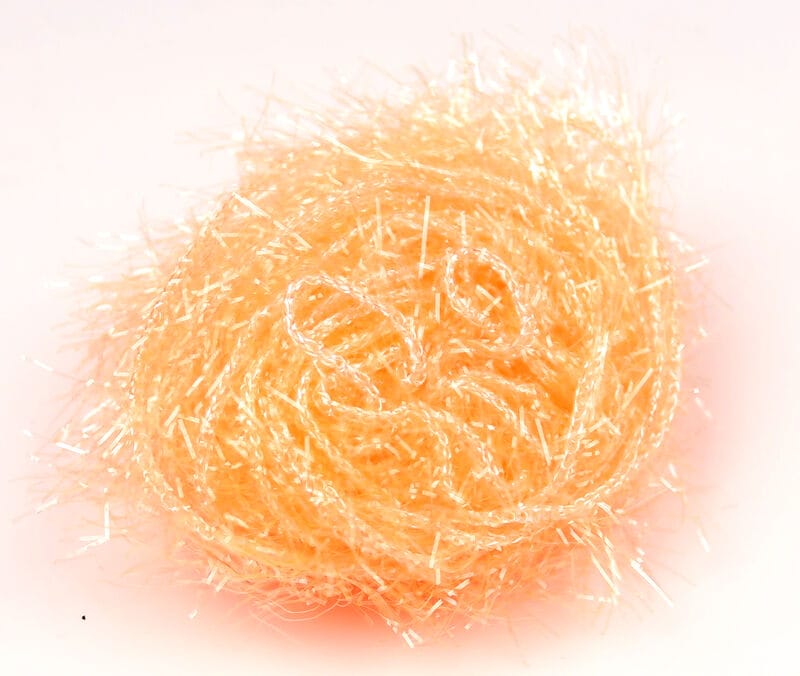 Peach-orange Hareline Polar Chenille bundle with iridescent tinsel fibers, fluffy fly-tying chenille yarn