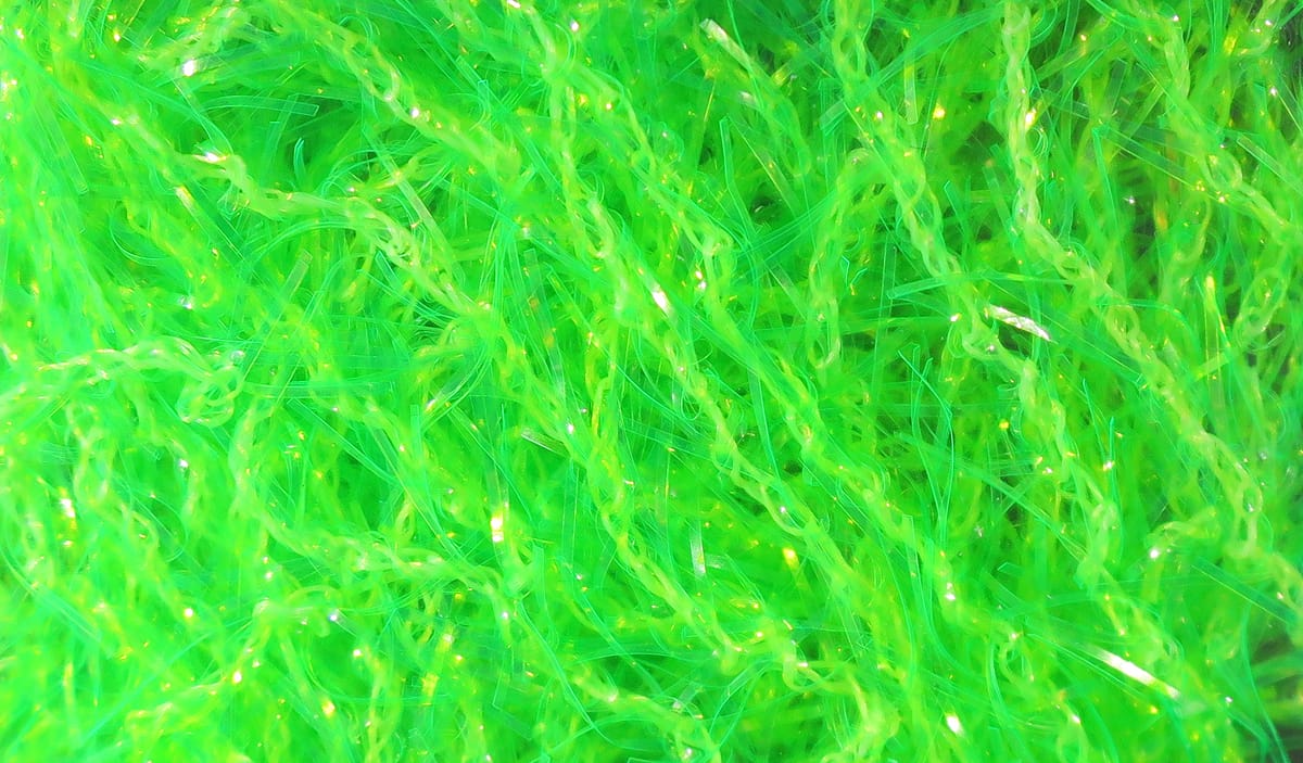 Chartreuse Hareline Polar Chenille strands with fuzzy synthetic fibers and iridescent tinsel for fly tying