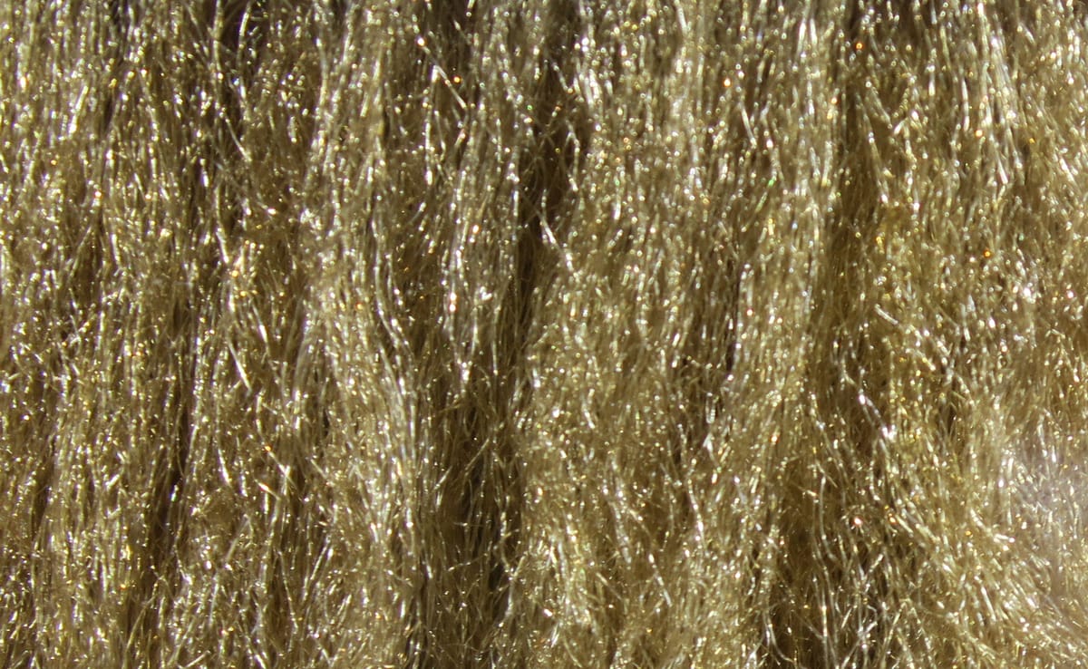 Hareline Sparkle Emerger yarn, olive-gold synthetic fibers with fine glittering strands, shimmering material for fly tying