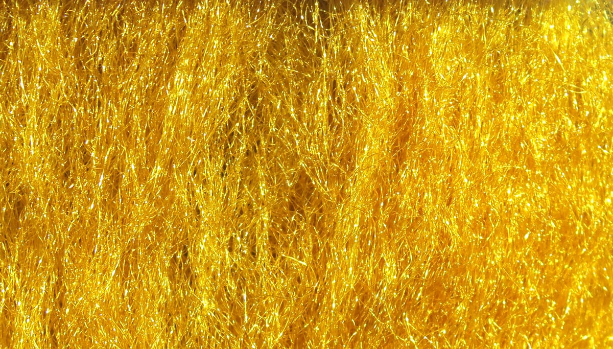 Bright gold Hareline Sparkle Emerger yarn with fine shimmering synthetic fibers, tinsel-like sparkle for fly tying