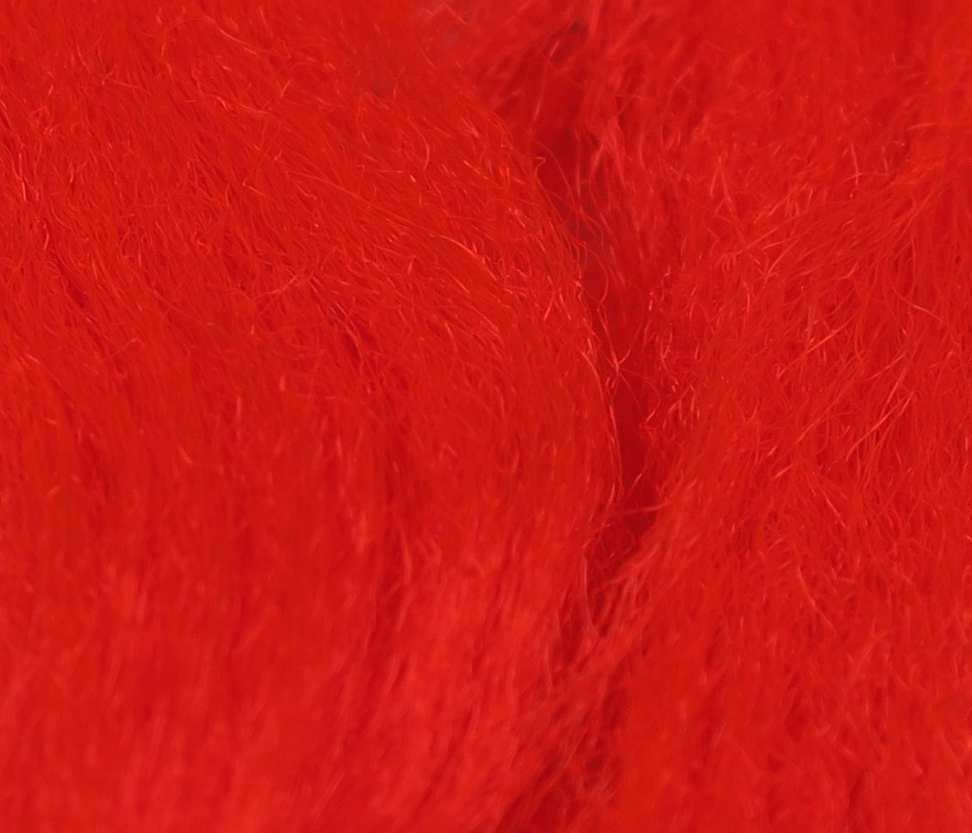 Bright red Hareline Sparkle Emerger yarn, fluffy synthetic fibers with subtle shimmer for fly tying