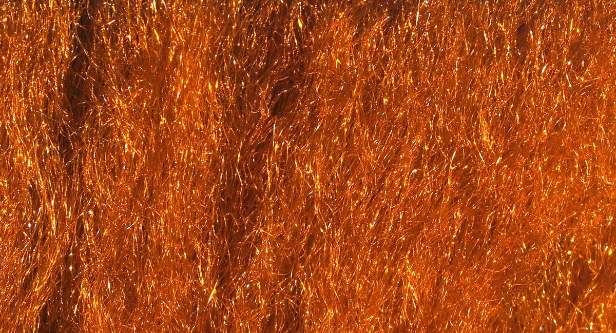 Copper-orange metallic sparkle emerger yarn, dense shimmery synthetic fibers for fly tying and lure bodies