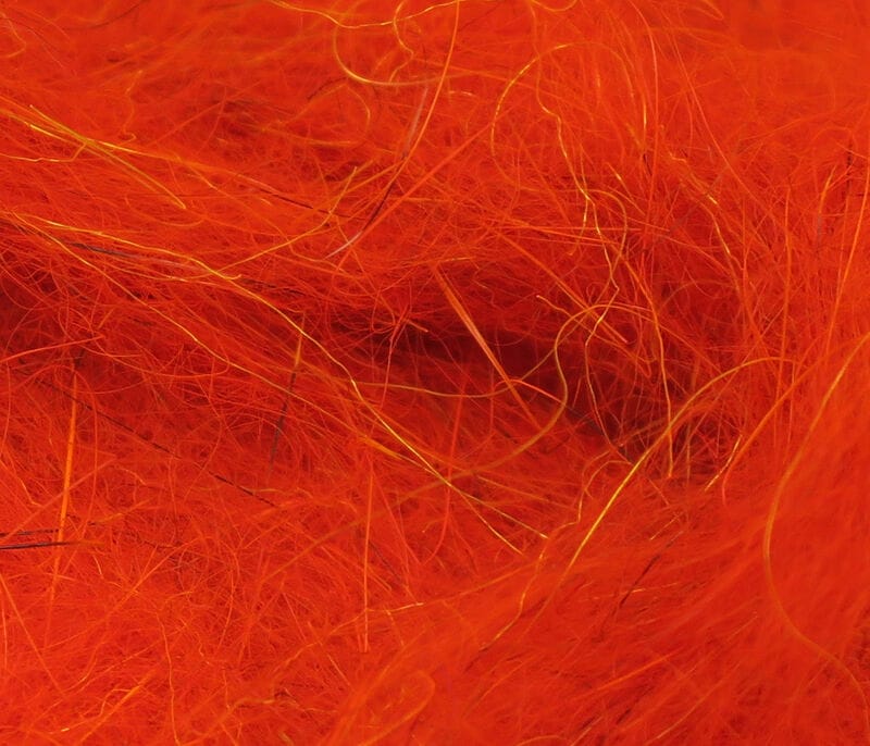 Bright orange Hareline squirrel hair dubbing fibers with fine wispy texture and occasional golden guard hairs for fly tying