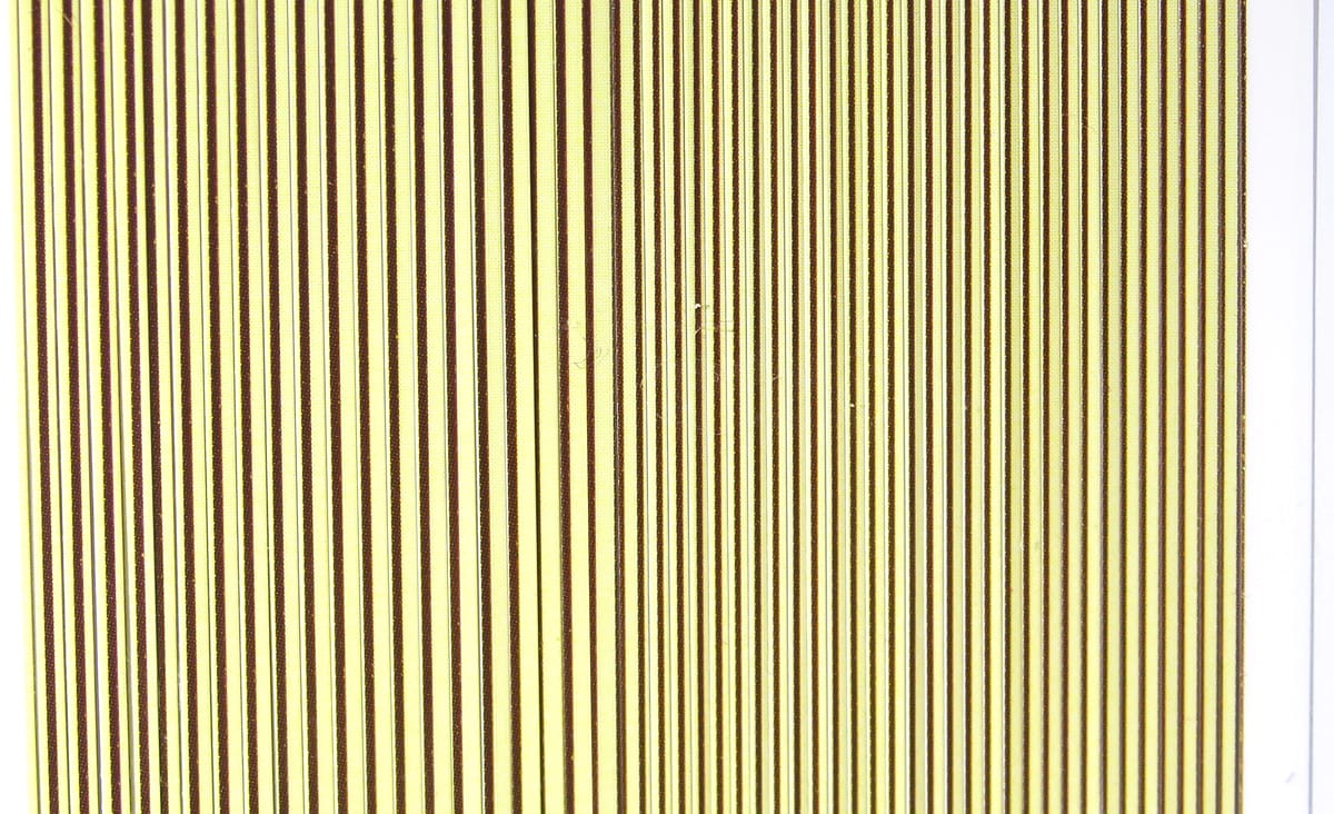 Hareline synthetic quill body wrap, pale yellow sheet with evenly spaced thin dark brown vertical stripes for fly tying.
