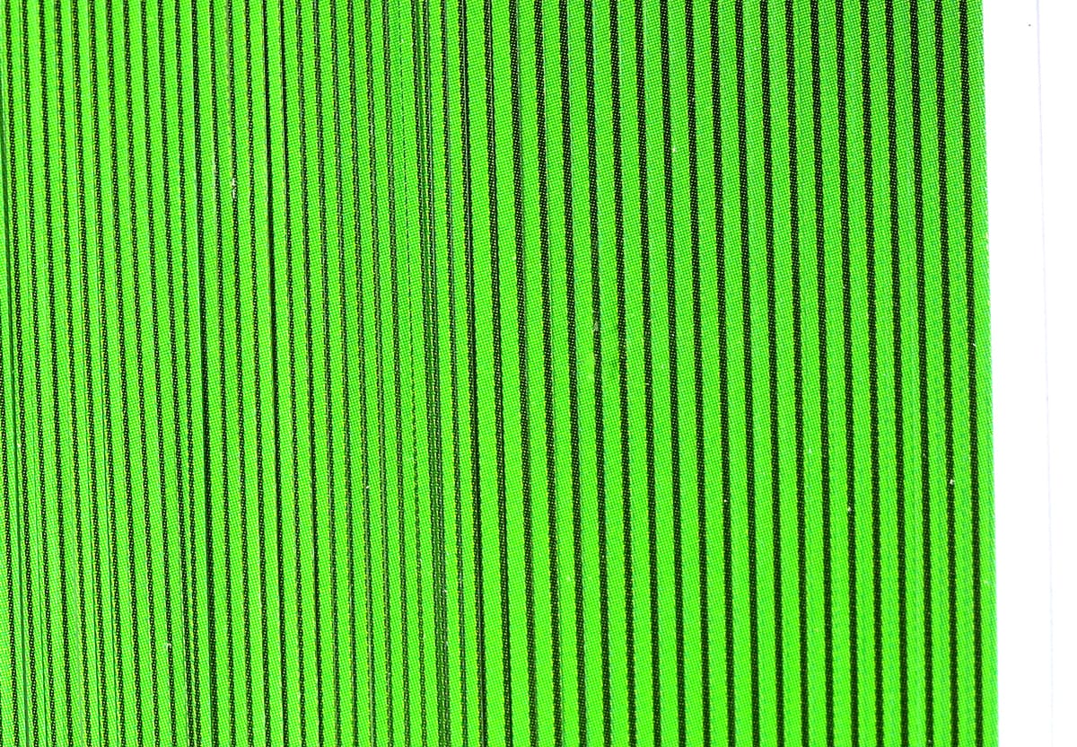 Bright neon green synthetic quill body wrap with thin black vertical stripes for fly tying