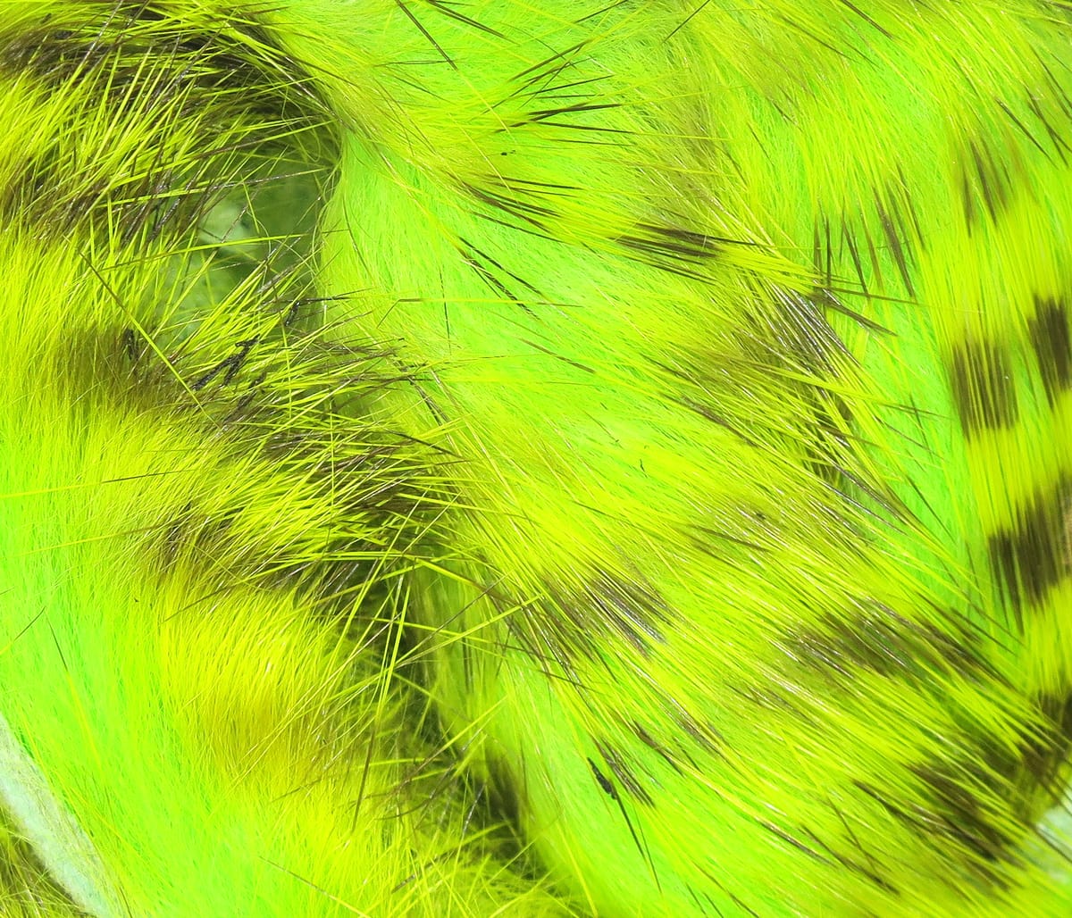 Tiger-barred rabbit fur strips in bright chartreuse green with dark brown bars, soft material for fly tying