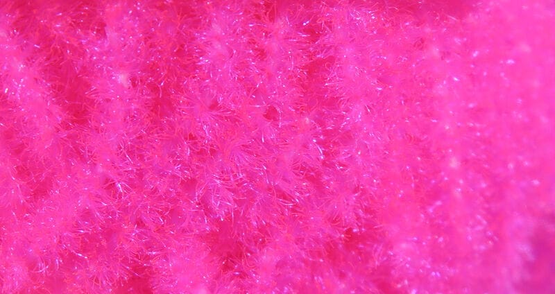 Hareline Trilobal Antron chenille bright hot pink with sparkly fibers, fuzzy plush texture for fly tying