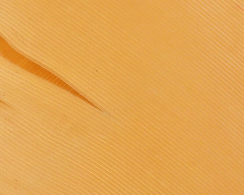 Hareline pale orange turkey biot quill with fine ribbed feather texture for fly tying