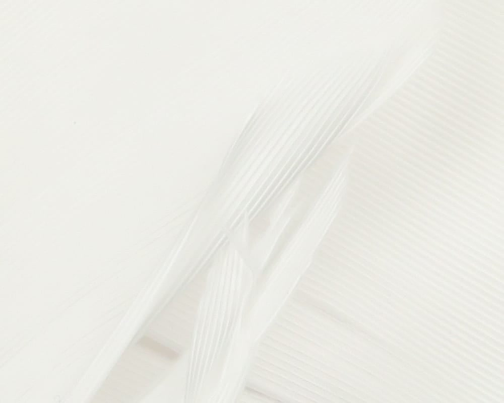 White Hareline turkey biot quills close-up showing glossy ribbed feather strips for fly tying