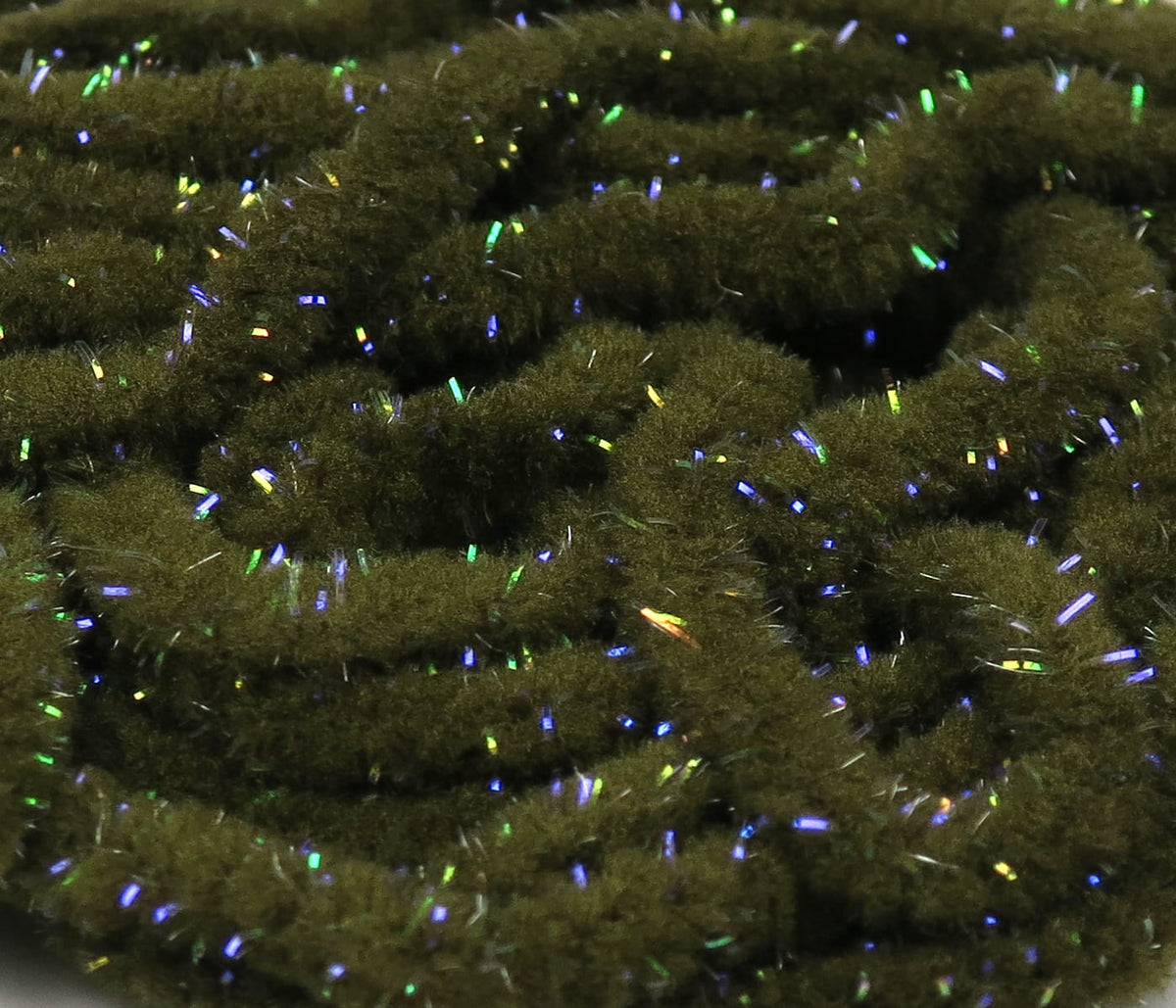 Olive green UV Galaxy mop chenille with dense fuzzy fibers and blue-green iridescent tinsel strands for fly tying